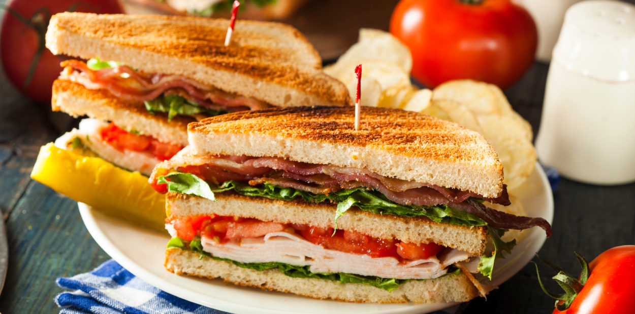 Turkey and Bacon Club Sandwich with Lettuce and Tomato