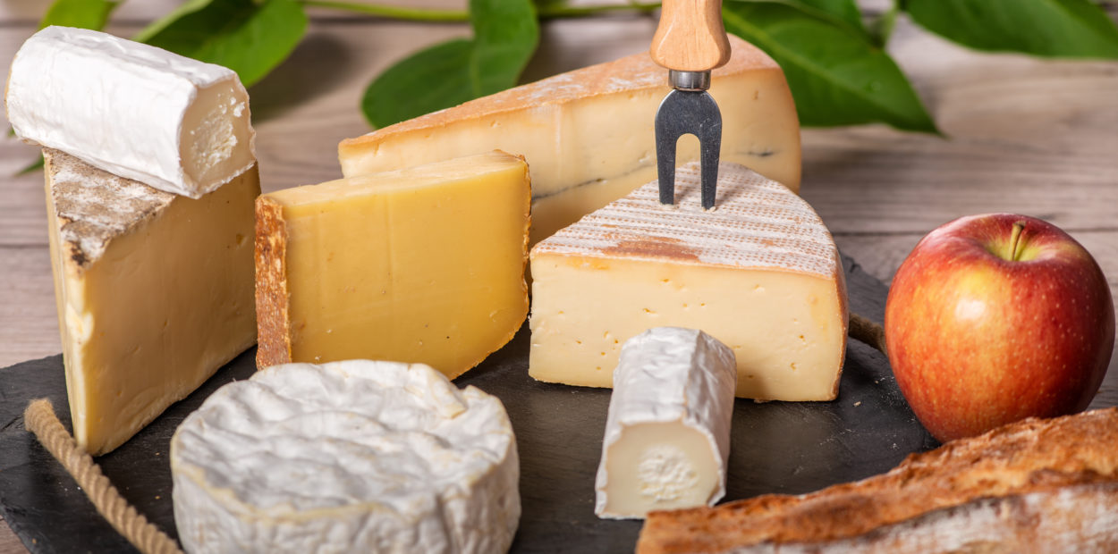 a platter of different french cheeses